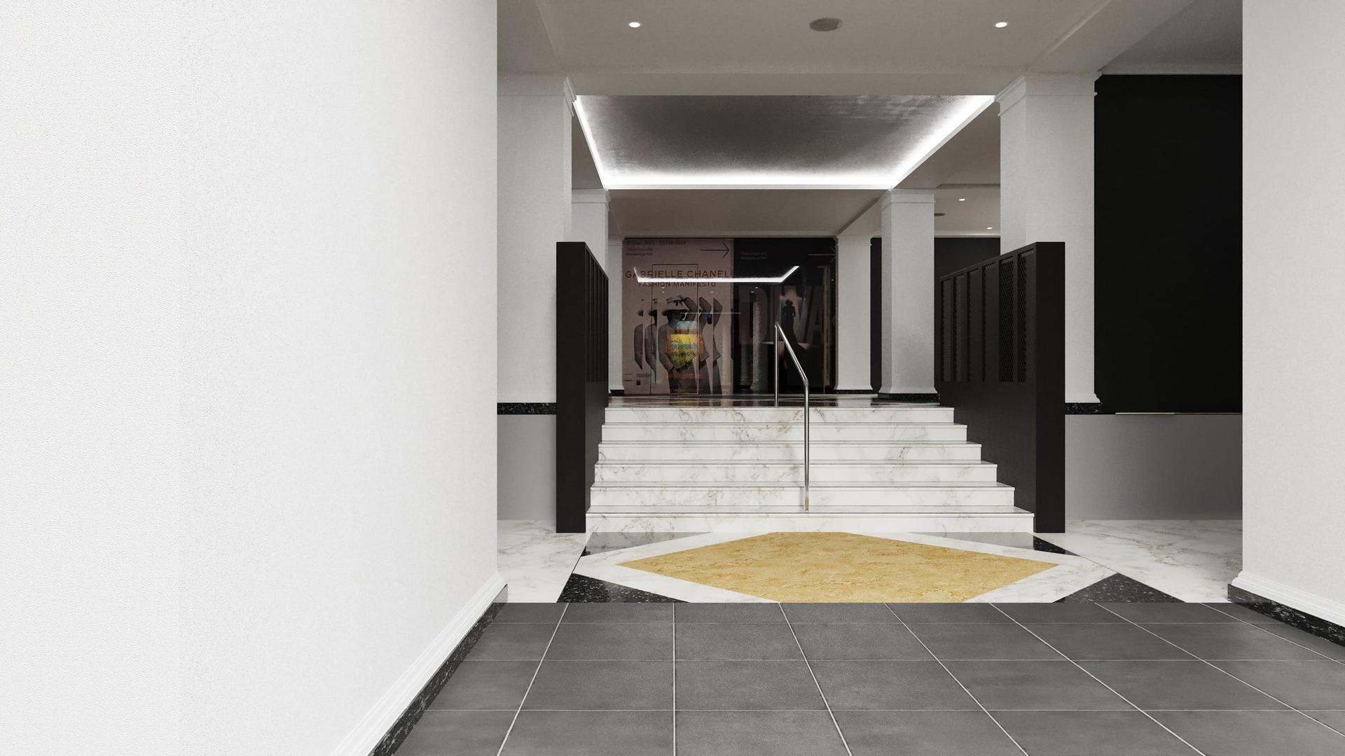 Retail fit-out — a white marble stair rising between black wall panels to a shopfloor beyond