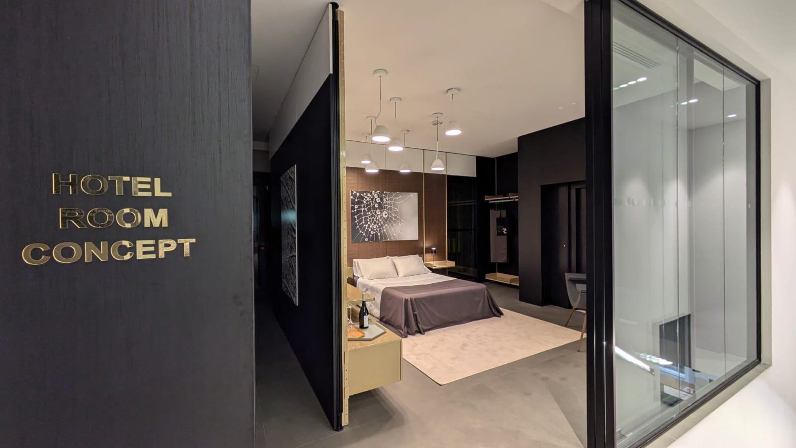 Hotel room concept mock-up behind a glazed screen, signed Hotel Room Concept on the door