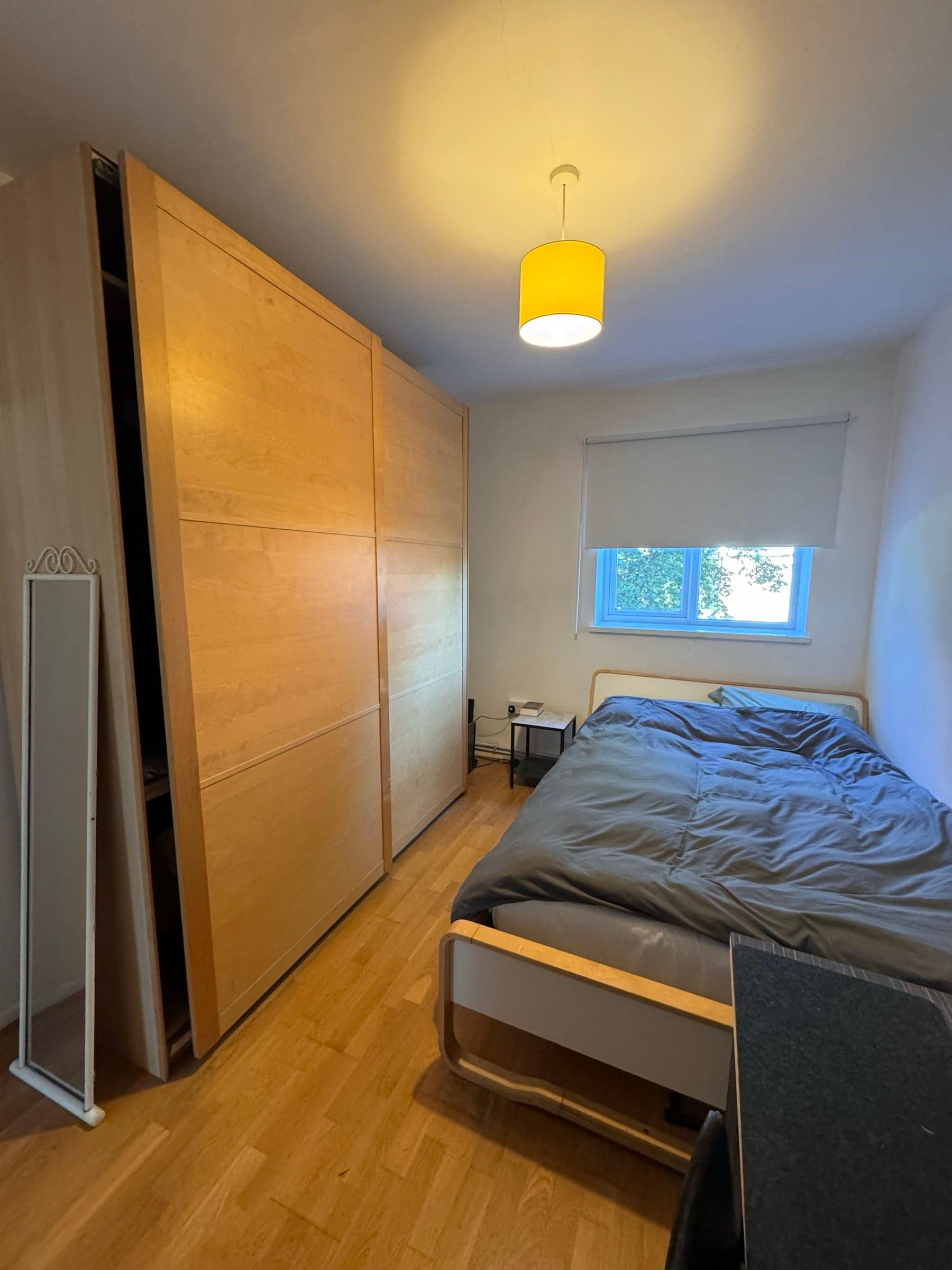 Bedroom with a birch-faced sliding wardrobe run