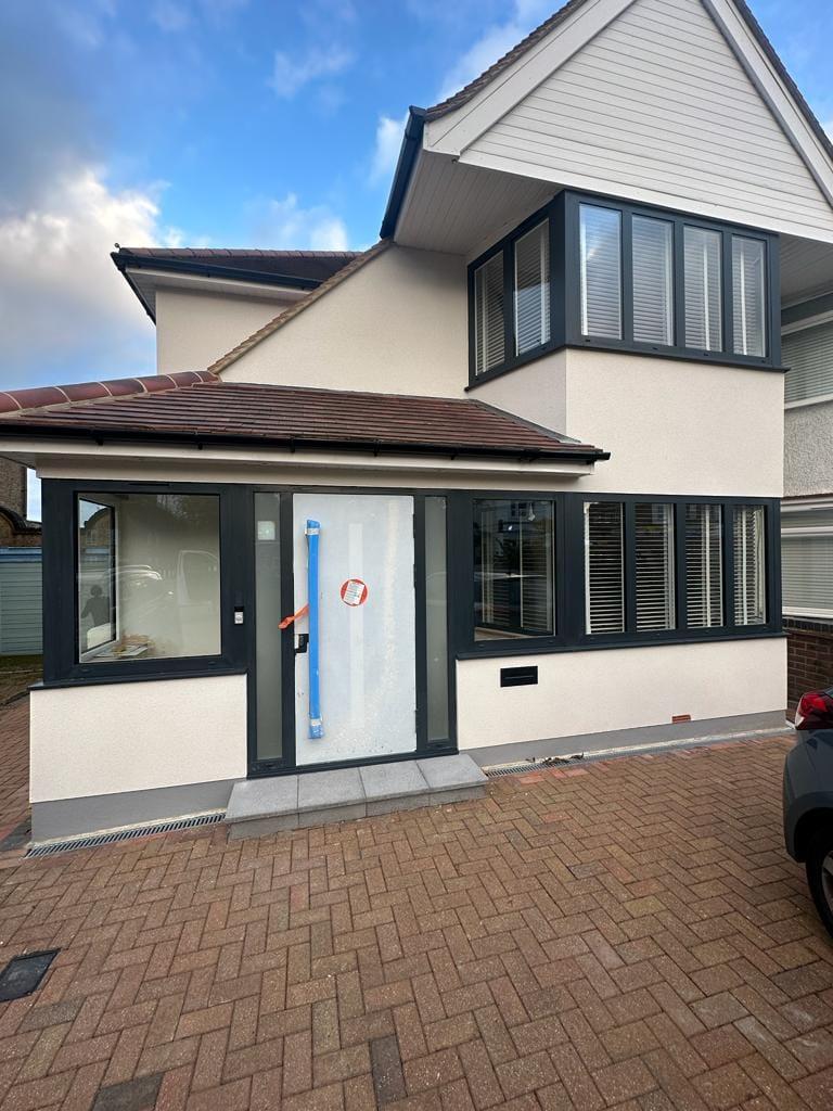 Rendered house exterior with anthracite aluminium windows and a new block-paved drive