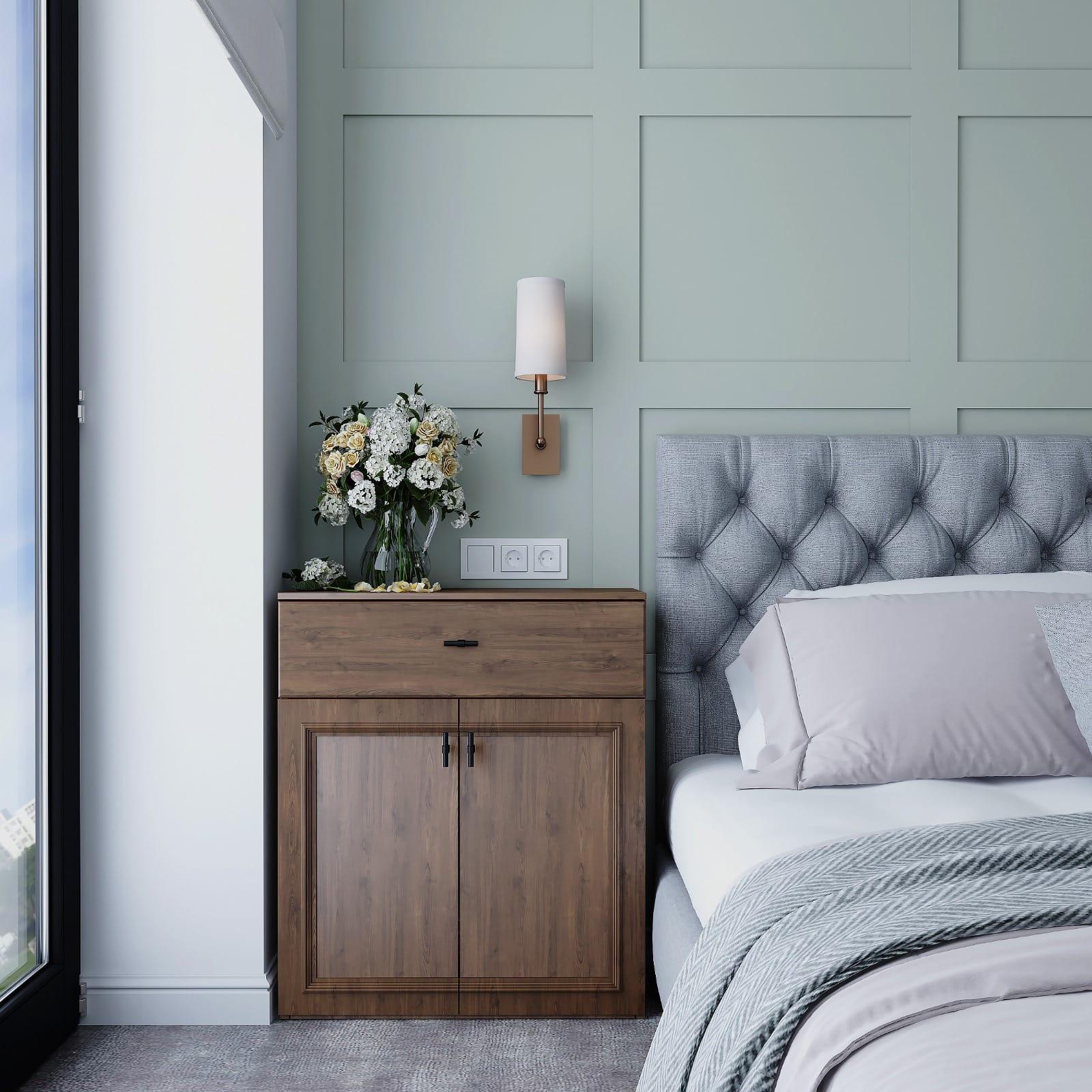 Bedroom corner in sage panelling with a buttoned headboard and a walnut bedside cabinet