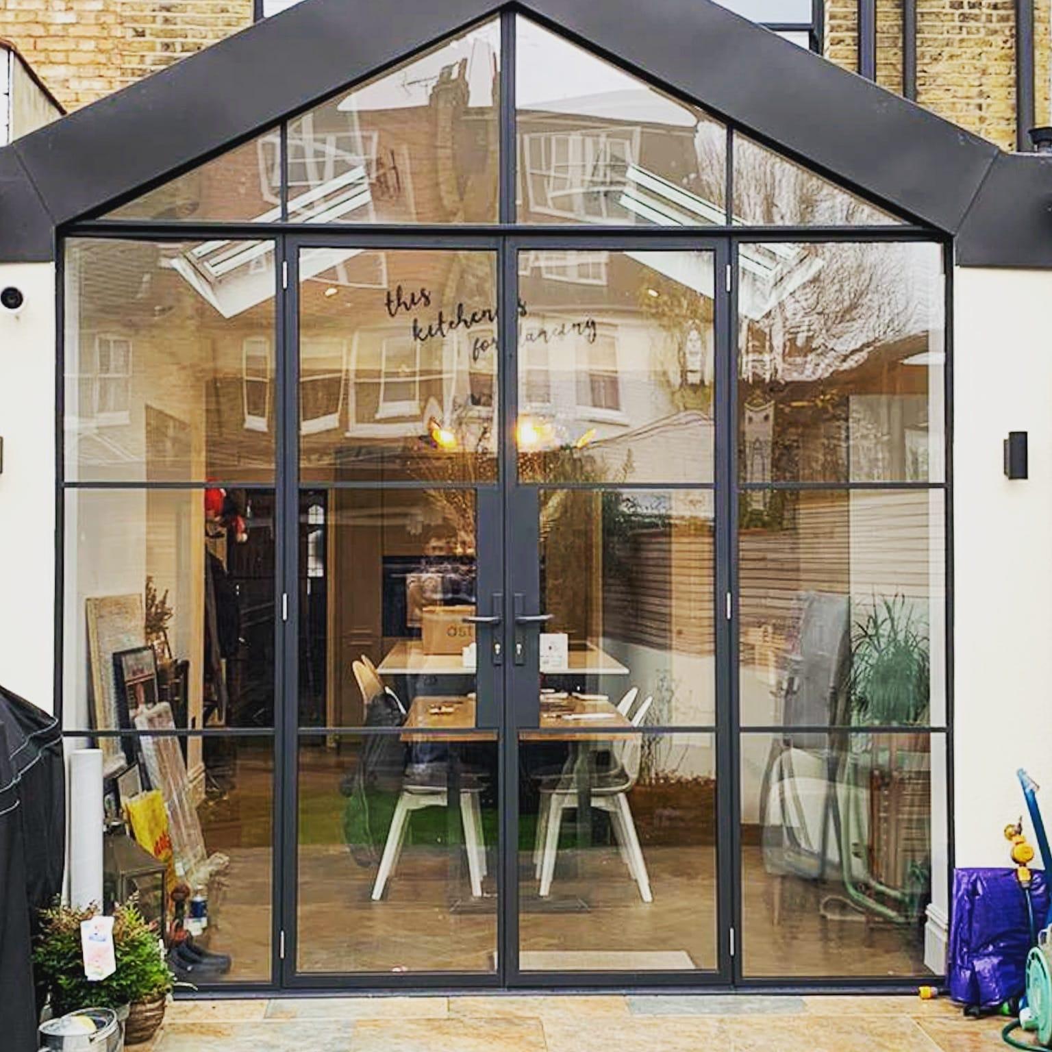 Glazed gable rear extension in a steel frame, seen from the garden of a London terrace