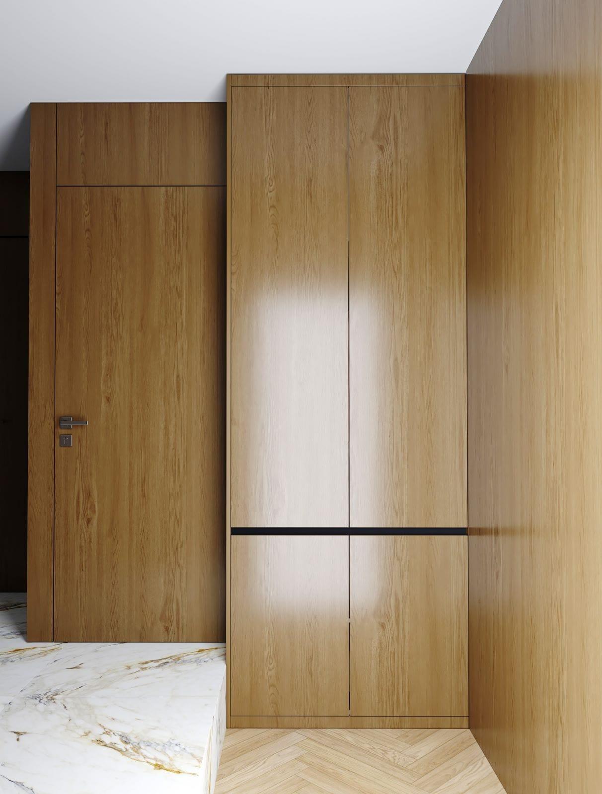 Full-height oak veneer wardrobe and door run being installed, a marble offcut still on the floor