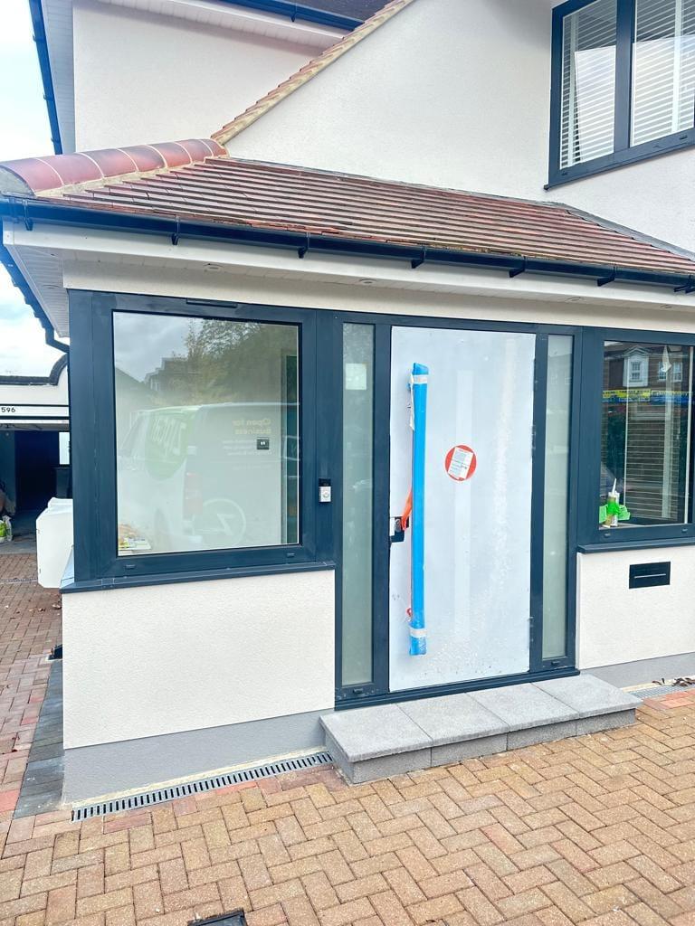 Single-storey rear addition in render with anthracite aluminium glazing and a tiled roof