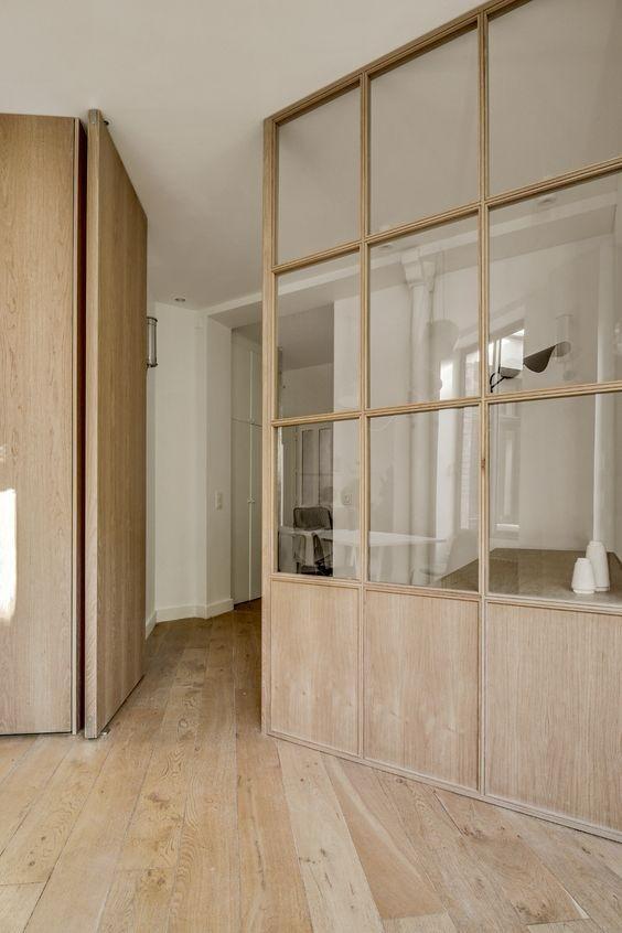 Oak-framed glazed screen with a pocket door, dividing a hallway over an oak floor