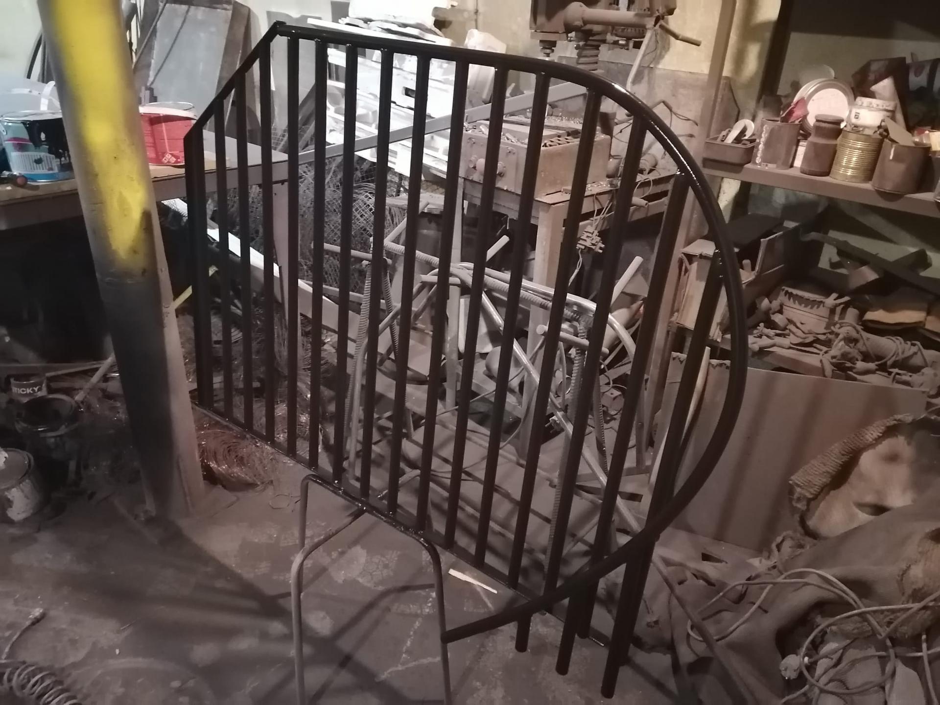 Curved steel balustrade frame fabricated in the workshop, before finishing