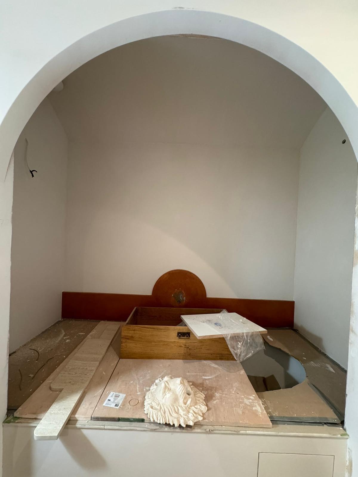 Plastered arched alcove formed over a window seat, before finishing