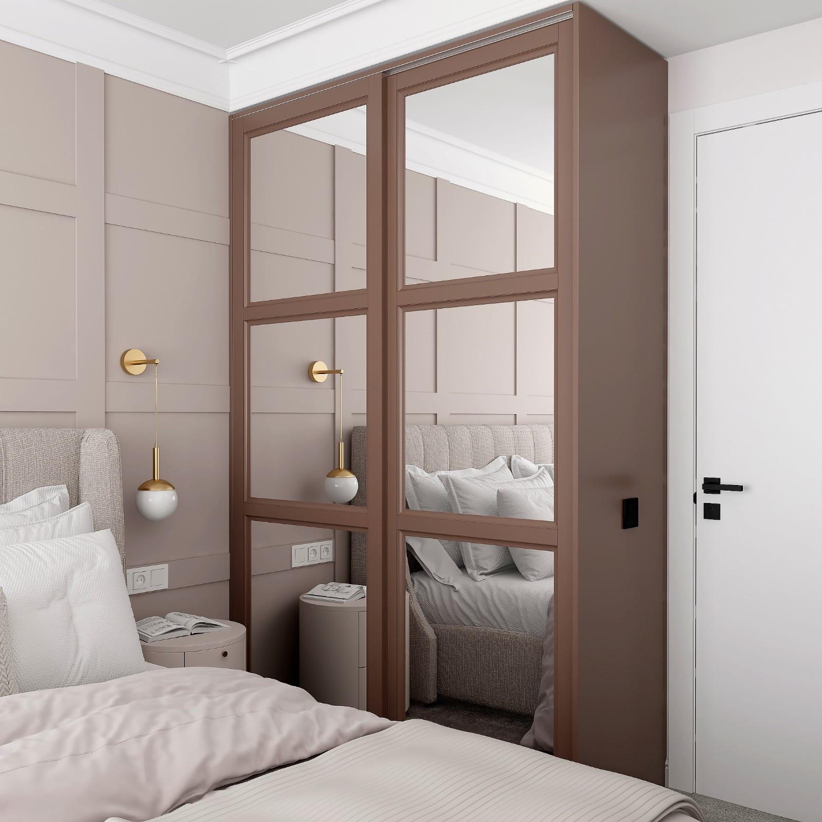 Mirrored wardrobe doors in a taupe frame beside a panelled bedroom wall
