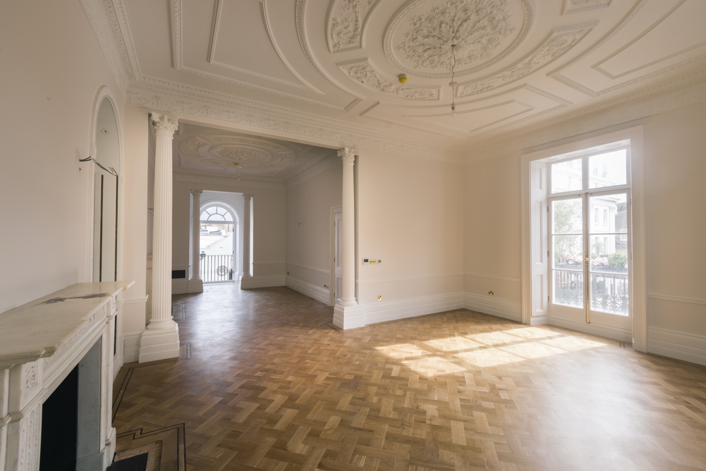 Double reception with restored plasterwork — Fluted Corinthian columns, enriched ceiling roses, marble chimneypiece, herringbone parquet