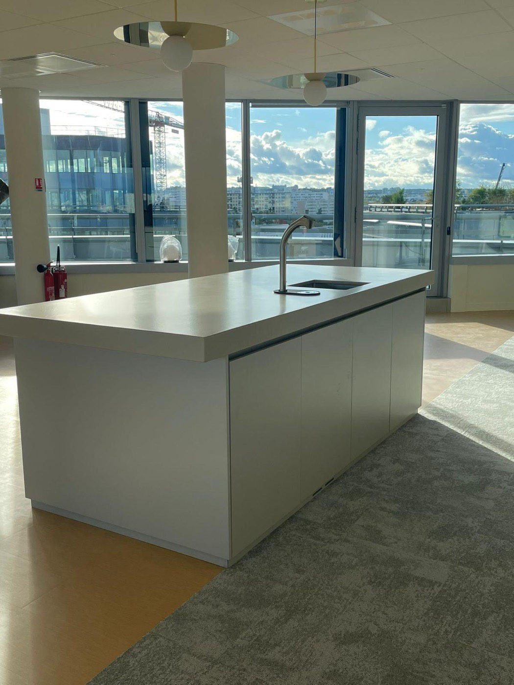 Seamless resin island worktop with an undermount sink, formed in place with no fabrication joint at the return